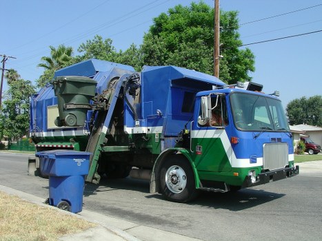 Homeowners using an enclosed skip for clean-up