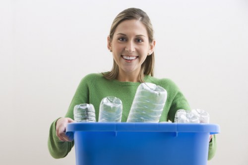 Operative performing waste assessment beside a skip